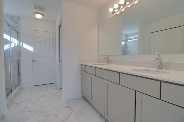 bathroom featuring vanity and a shower with door