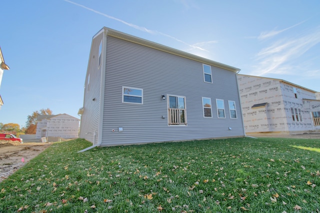 rear view of property with a lawn