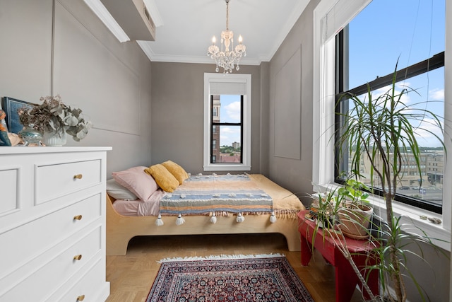 bedroom with ornamental molding, light parquet floors, and a notable chandelier