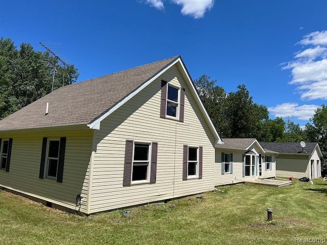 back of property featuring a yard