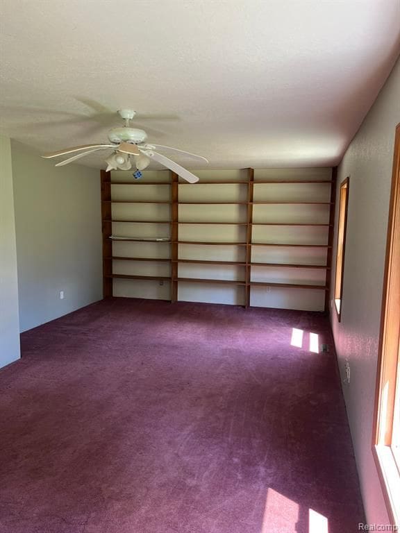 carpeted empty room with ceiling fan