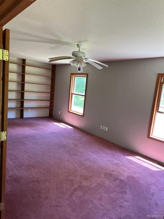 unfurnished room featuring carpet flooring and ceiling fan