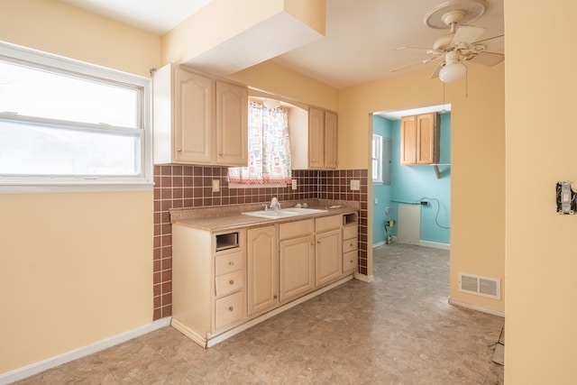 kitchen featuring sink, decorative backsplash, and ceiling fan