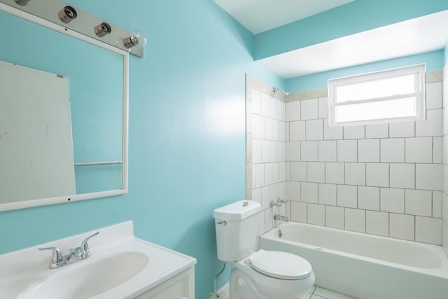 full bathroom with tiled shower / bath, vanity, and toilet