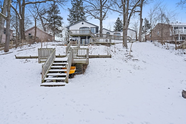 snowy yard featuring a wooden deck