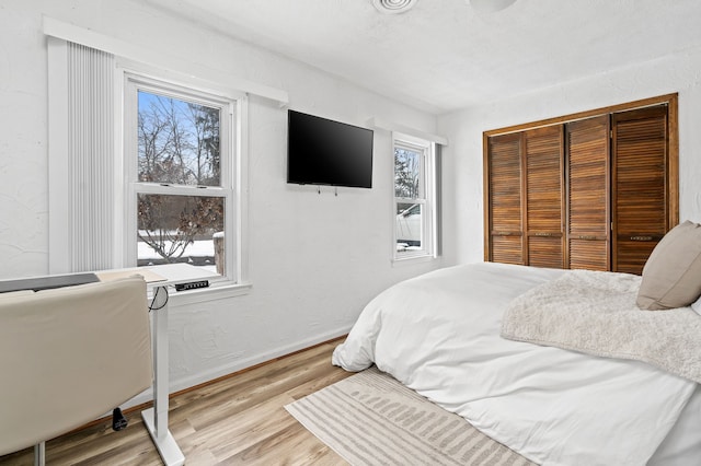 bedroom featuring a closet and light hardwood / wood-style flooring