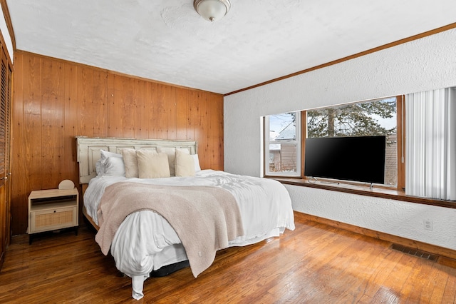 bedroom featuring hardwood / wood-style floors and ornamental molding