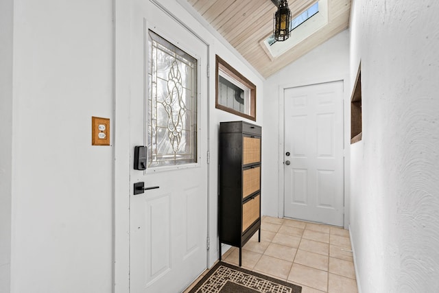 entryway featuring wooden ceiling, light tile patterned floors, and vaulted ceiling