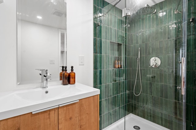 bathroom featuring vanity and a shower with shower door