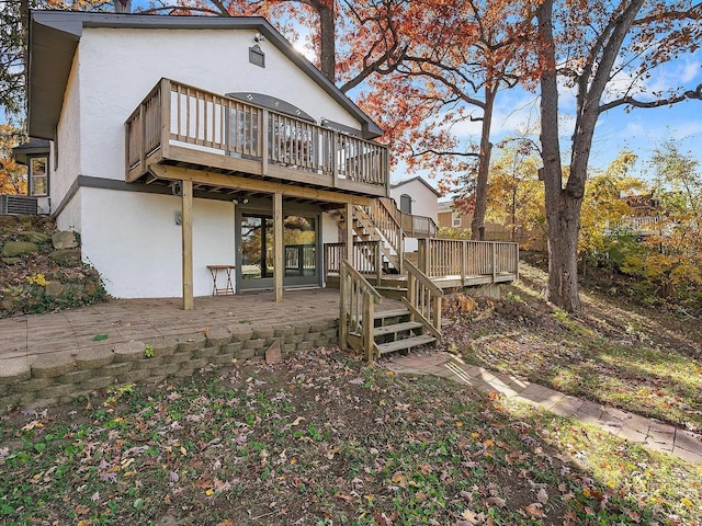 back of property featuring a patio area and a wooden deck