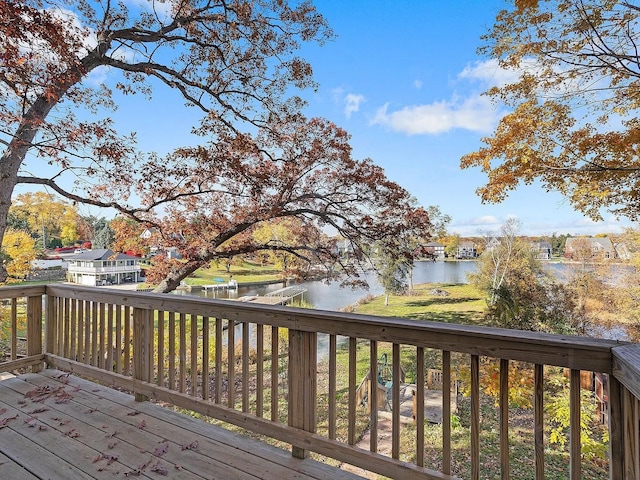 wooden terrace featuring a water view