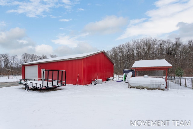 snow covered structure with a garage