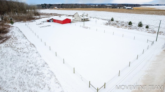 yard layered in snow with a rural view