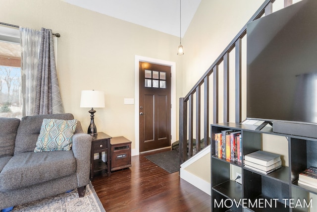 living room with dark hardwood / wood-style floors and lofted ceiling