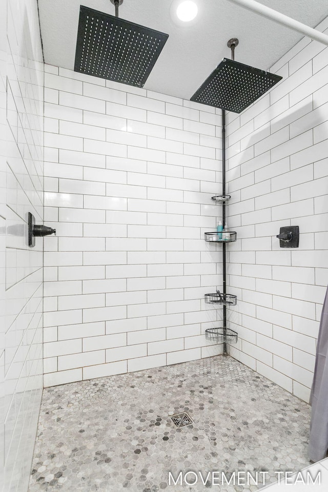 bathroom with a tile shower