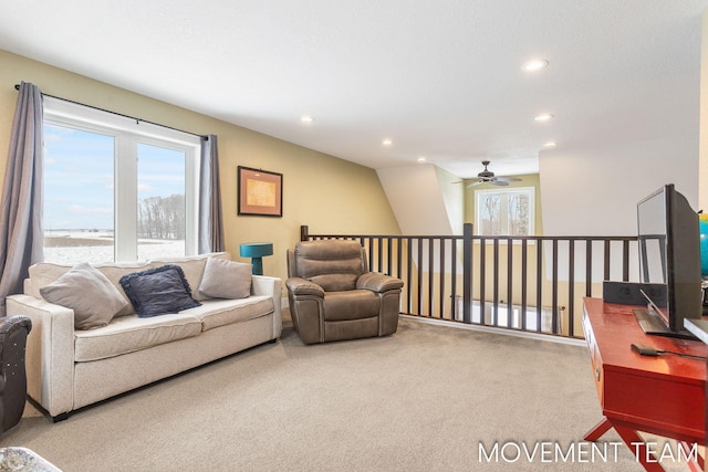 living room featuring carpet and ceiling fan