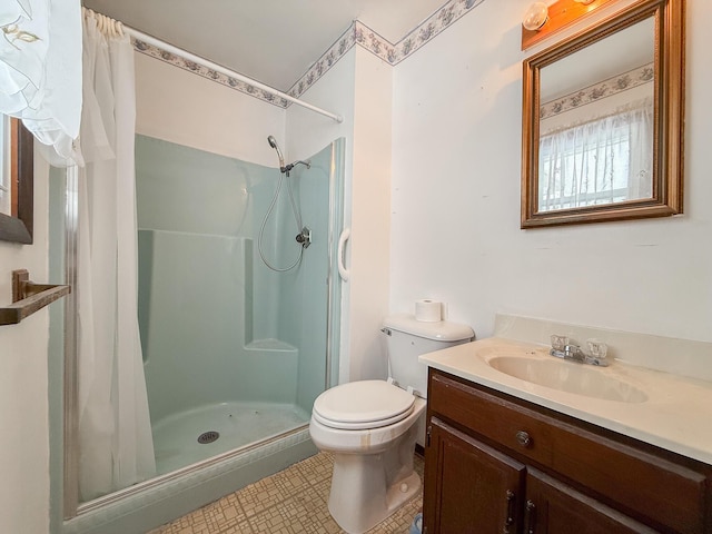 bathroom featuring tile patterned flooring, vanity, curtained shower, and toilet