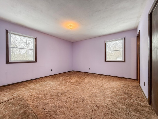 carpeted spare room featuring a textured ceiling