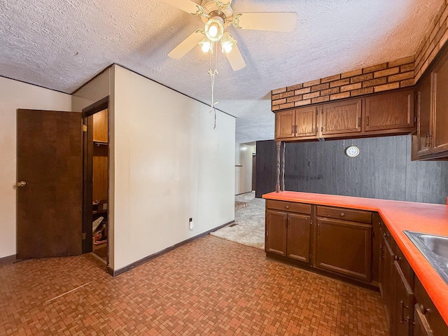 kitchen with ceiling fan and a textured ceiling