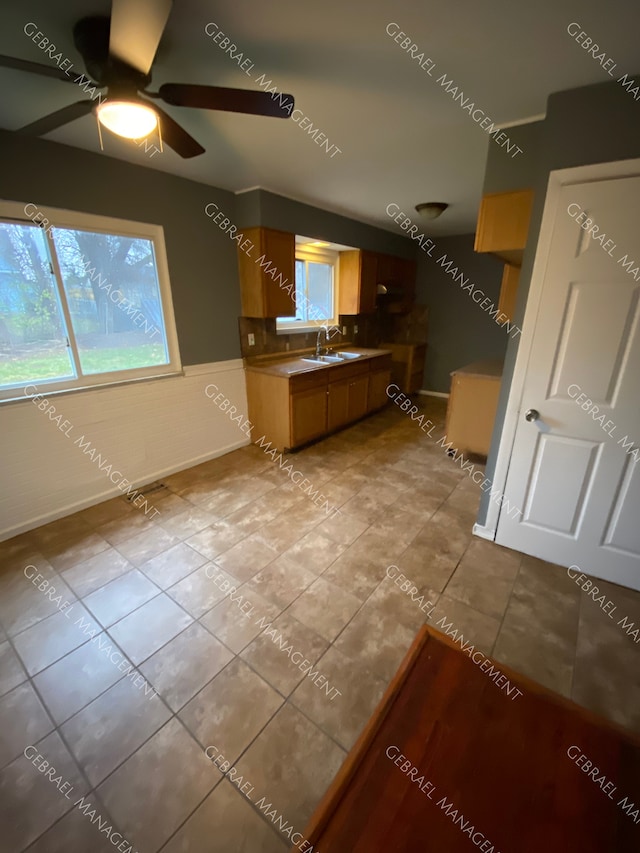 kitchen with ceiling fan, light tile patterned floors, and sink