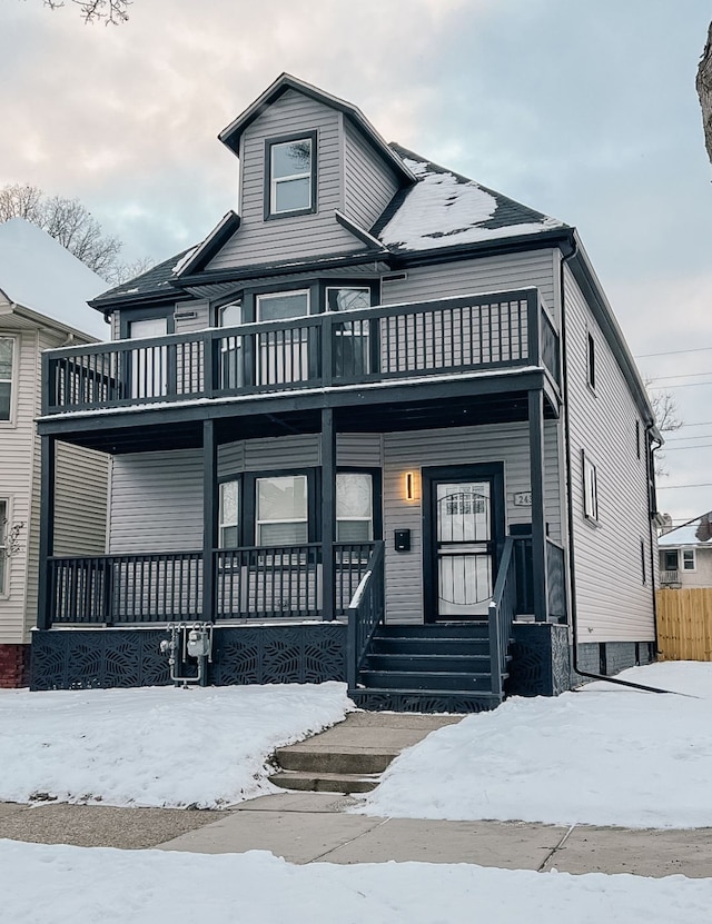 view of front of property with a balcony and covered porch