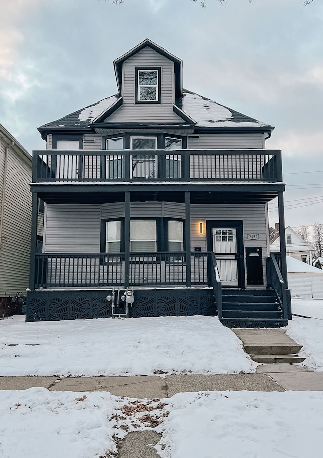 view of front of house with a porch and a balcony