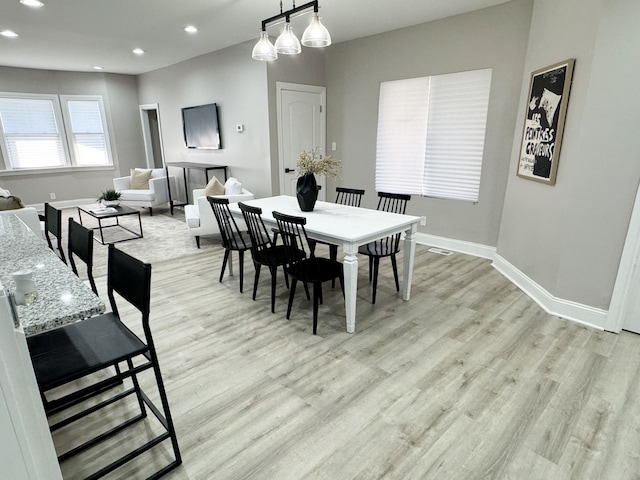 dining space with light hardwood / wood-style floors