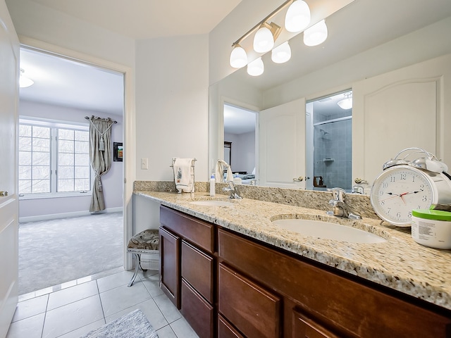 bathroom with tile patterned flooring, a shower with door, and vanity