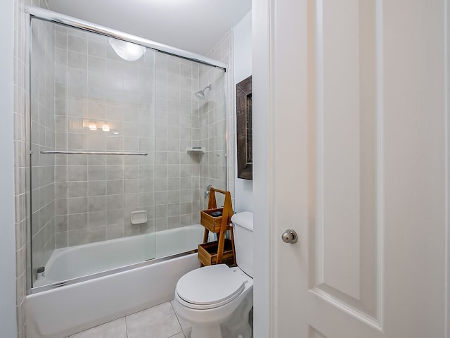 bathroom with toilet, tile patterned flooring, and enclosed tub / shower combo