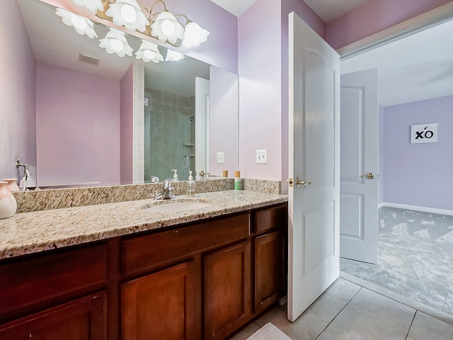 bathroom featuring vanity, tile patterned flooring, and walk in shower