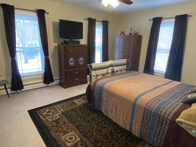 bedroom featuring ceiling fan, carpet floors, and a baseboard heating unit