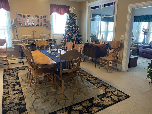 dining space with carpet flooring and a baseboard heating unit