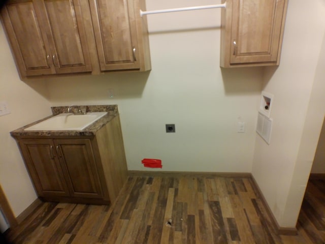 laundry area with dark wood finished floors, a sink, electric dryer hookup, and hookup for a washing machine