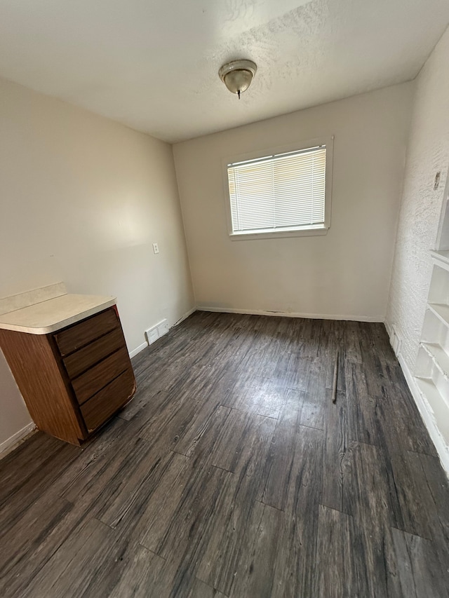 empty room with dark hardwood / wood-style floors