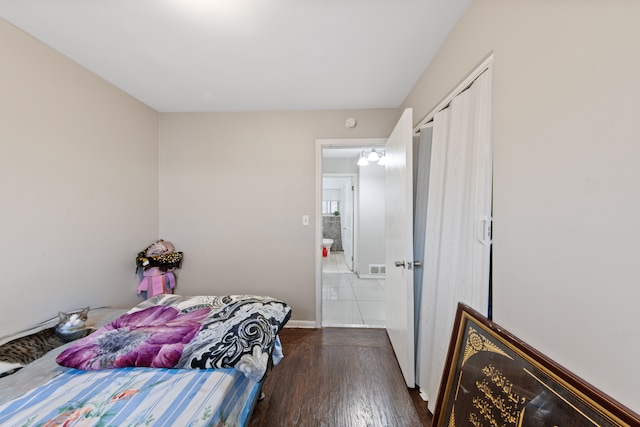 bedroom featuring a closet and dark hardwood / wood-style flooring