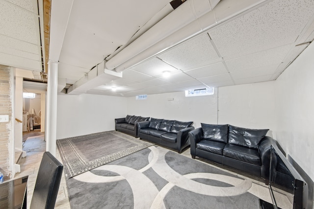 living room featuring a paneled ceiling