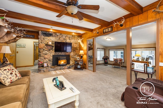 carpeted living room featuring ceiling fan and lofted ceiling with beams