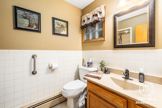 bathroom with vanity, a baseboard heating unit, and toilet