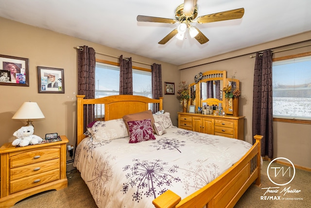 carpeted bedroom with baseboard heating and ceiling fan