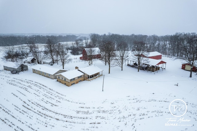 snowy aerial view featuring a rural view