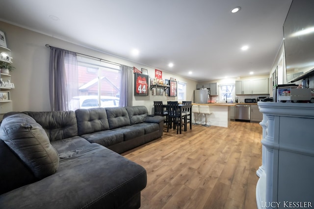 living room with sink and light wood-type flooring