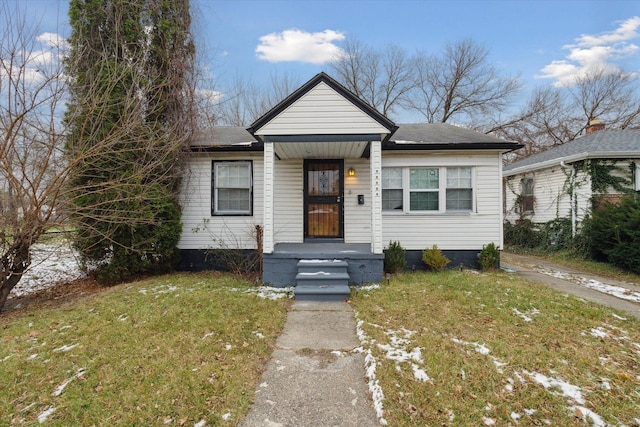 bungalow-style house with a front lawn