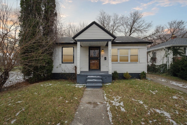 bungalow-style house with a lawn