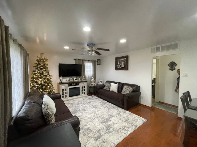 living room with ceiling fan and hardwood / wood-style flooring