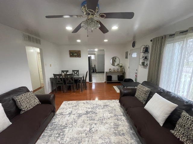 living room featuring ceiling fan and wood-type flooring