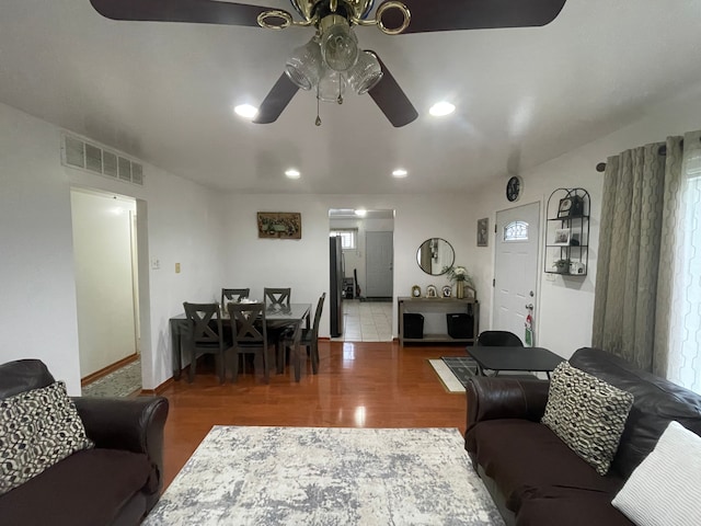 living room with ceiling fan and hardwood / wood-style flooring