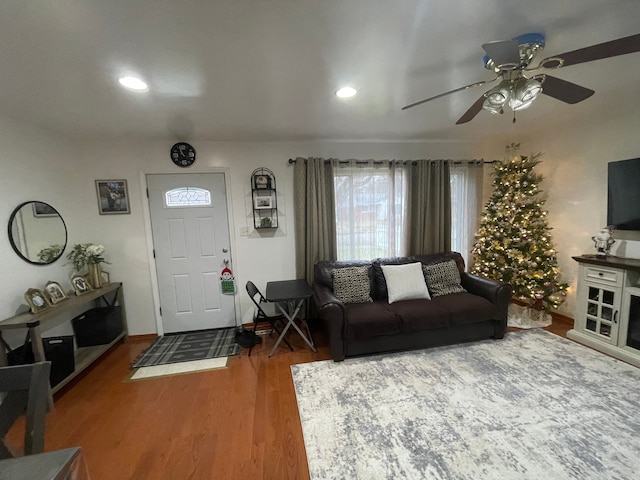 living room featuring hardwood / wood-style flooring and ceiling fan