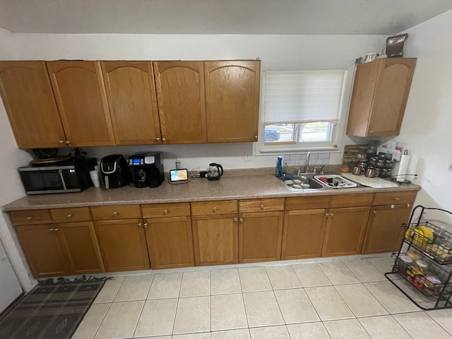 kitchen with light tile patterned floors and sink