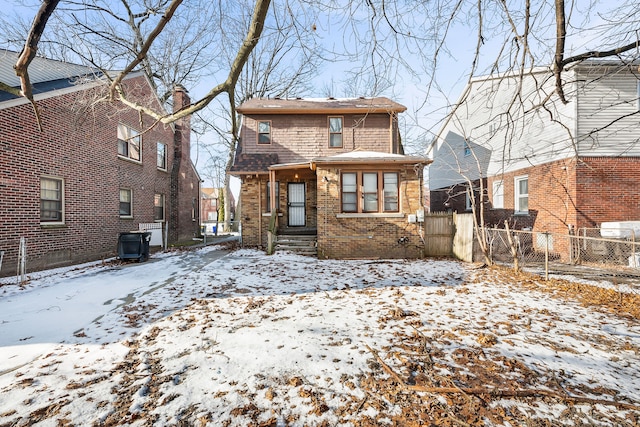 view of snow covered rear of property