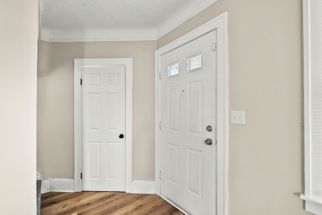 entryway with hardwood / wood-style floors and a textured ceiling